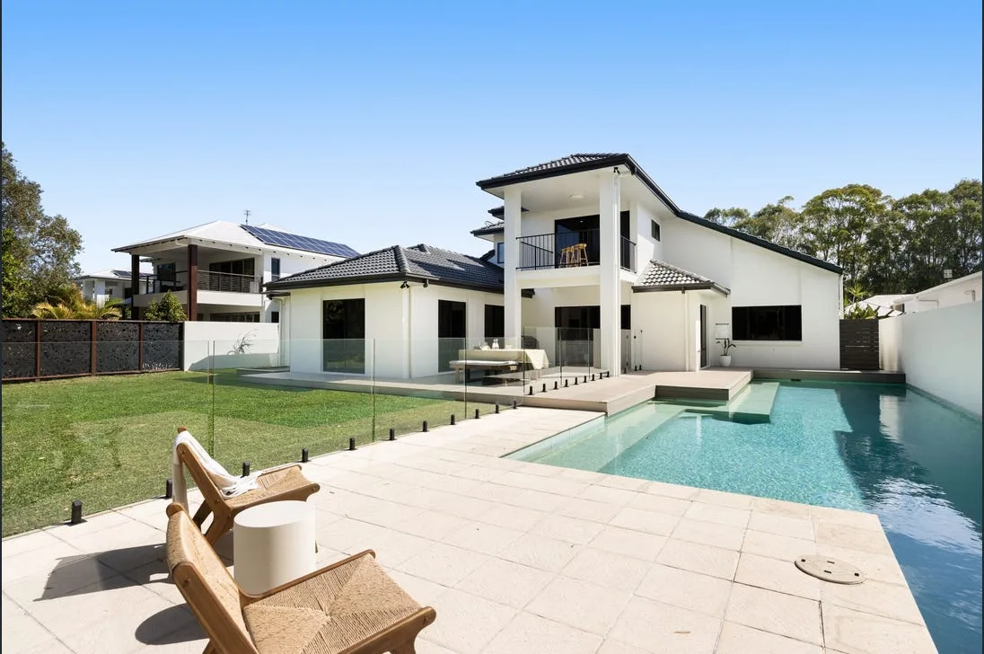 Frameless glass pool fencing beside a modern home